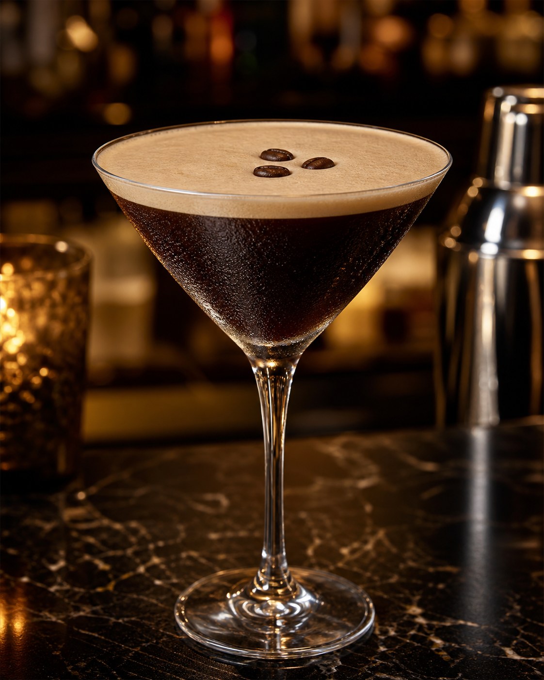 Espresso Martini in a chilled coupe, dense brown crema crown on top with three coffee beans floating, dark moody bar background